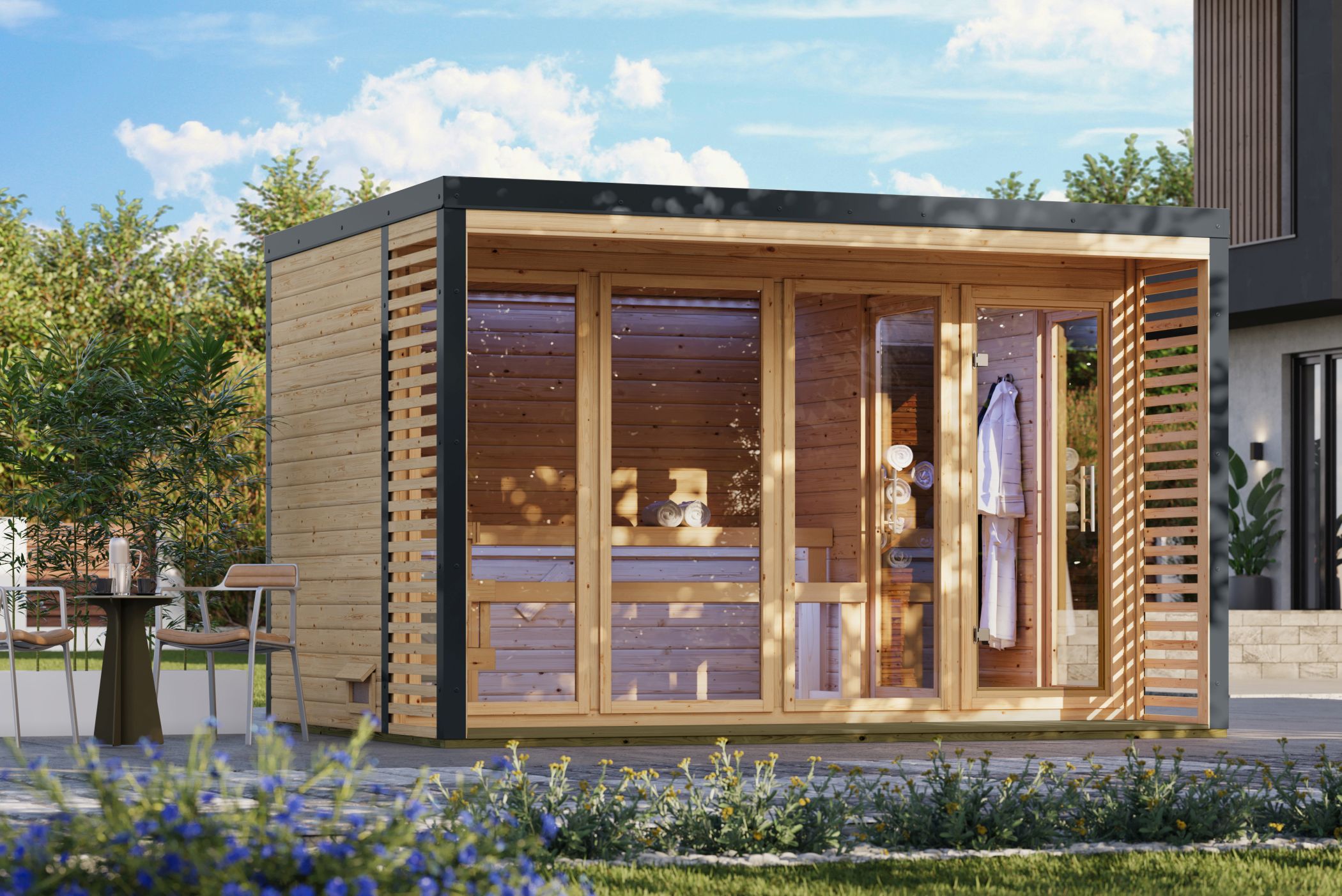 Karibu Saunahaus Ares 4 als Gartensauna aus Massivholz im Garten mit Glasfront